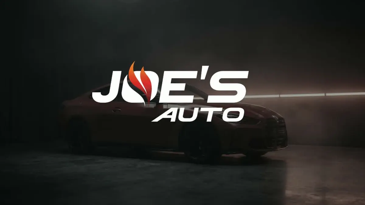 Joe's Auto logo over a car in the spray booth